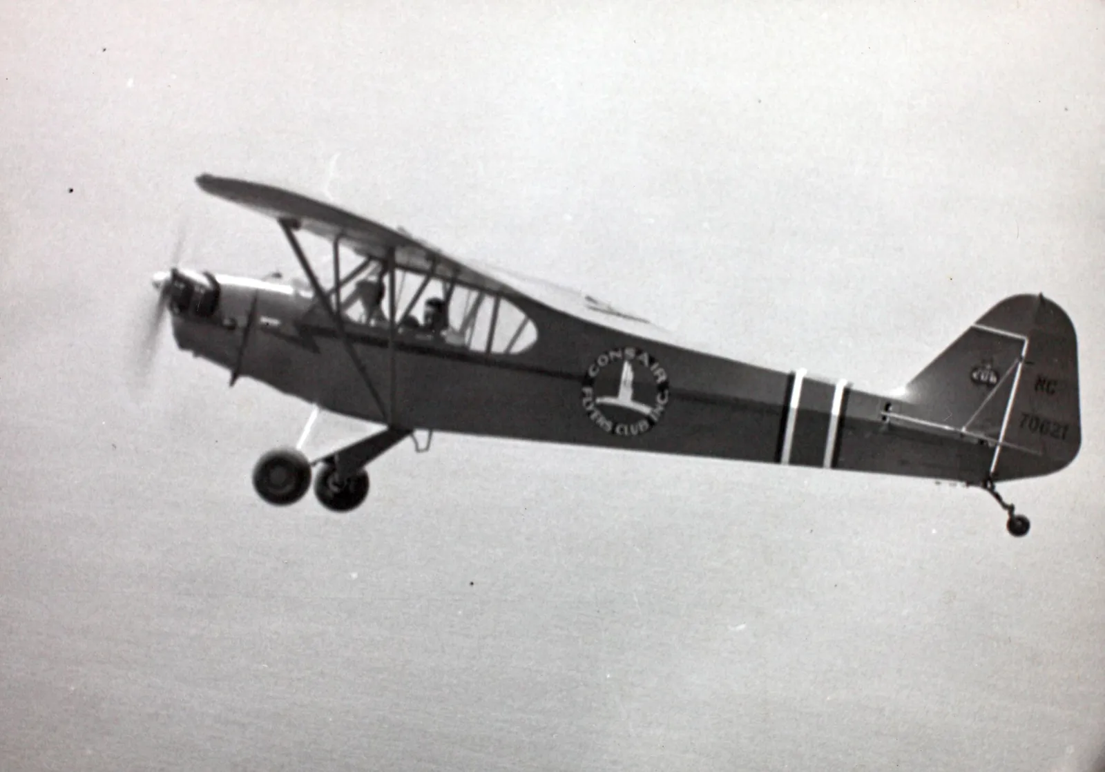 Classic yellow Piper J-3 Cub aircraft parked on grass, showing the iconic color scheme from the 1940s